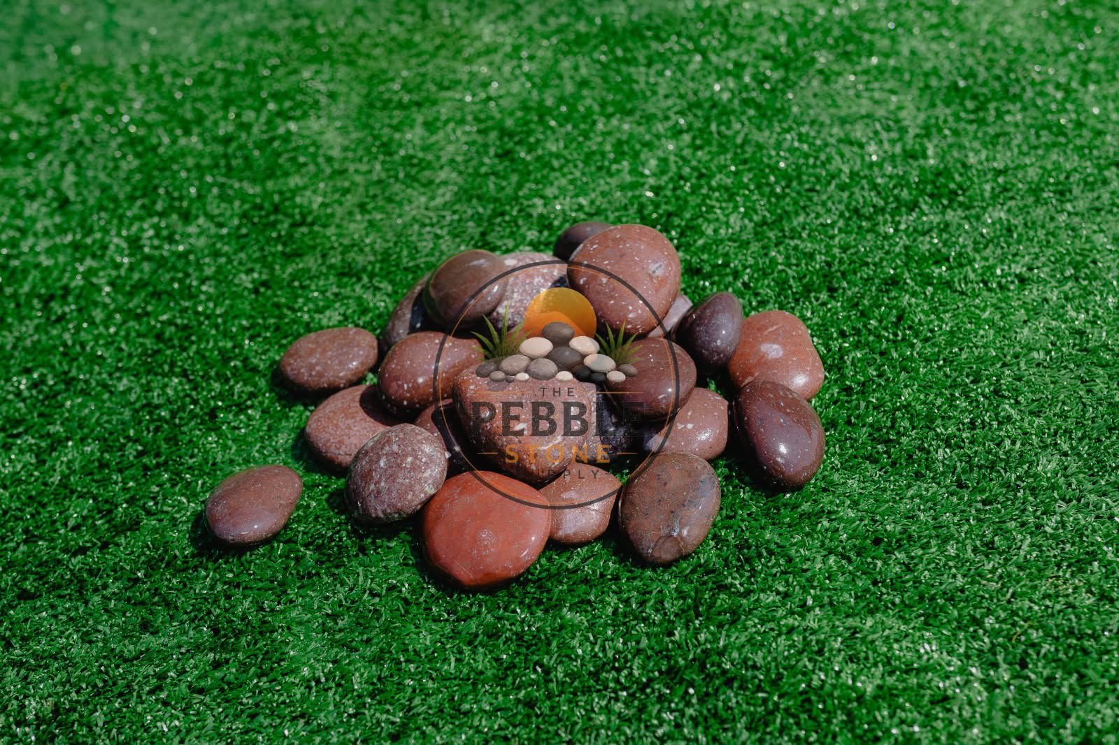 Red pebble stones for decorative landscaping supply
